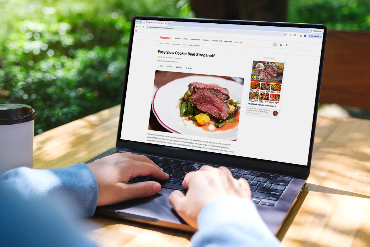 Grocer's digital circular running as an offsite ad alongside a recipe page on a laptop